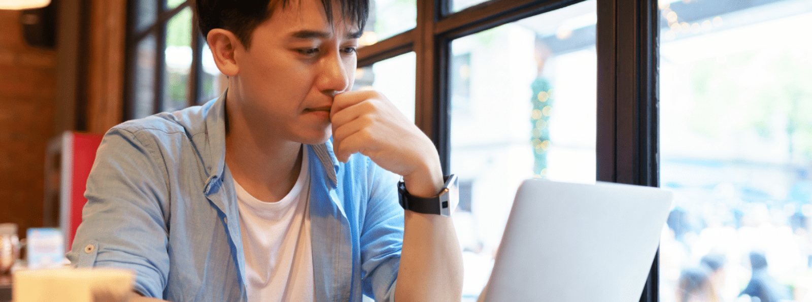 a man looking at his laptop computer