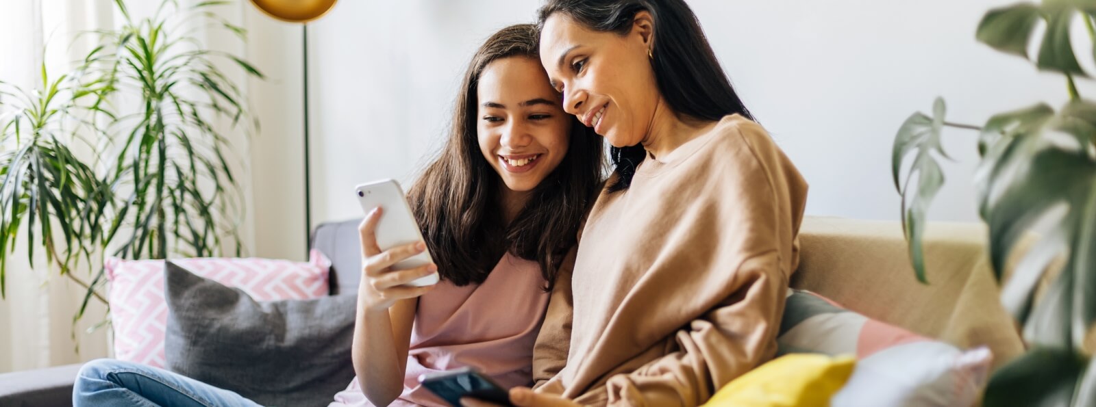 a mother and daughter viewing a mobile phone