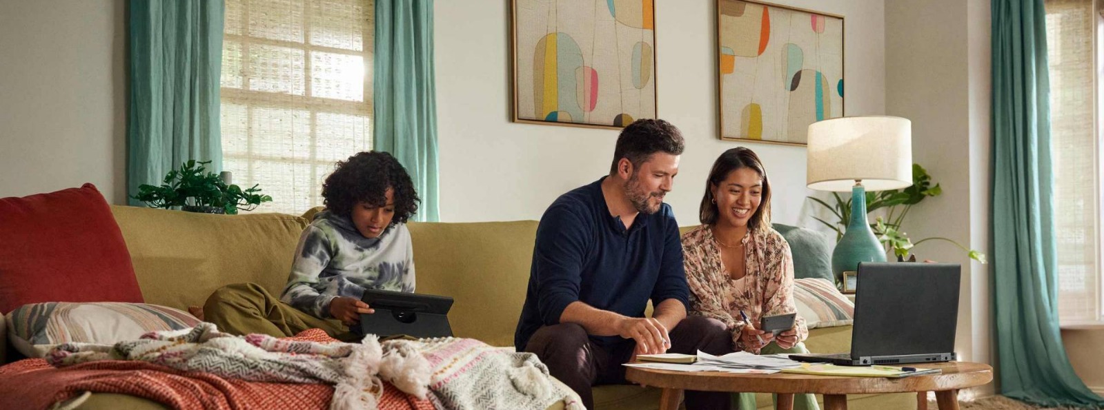 a family sitting on a couch in their living room