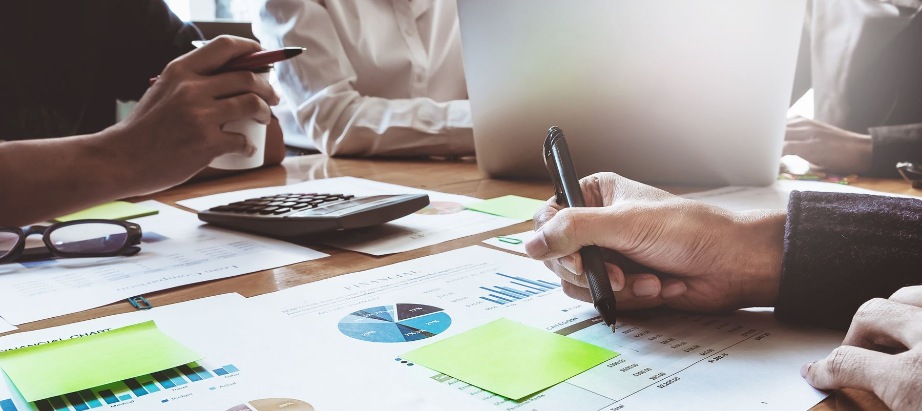 a group of people discussing financial documents